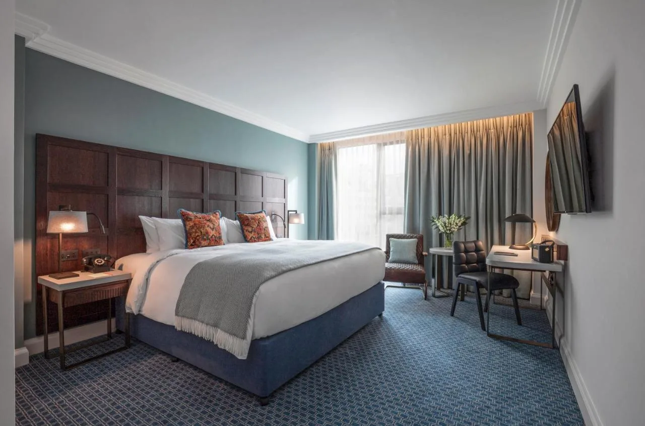Hotel bedroom with large bed and desk