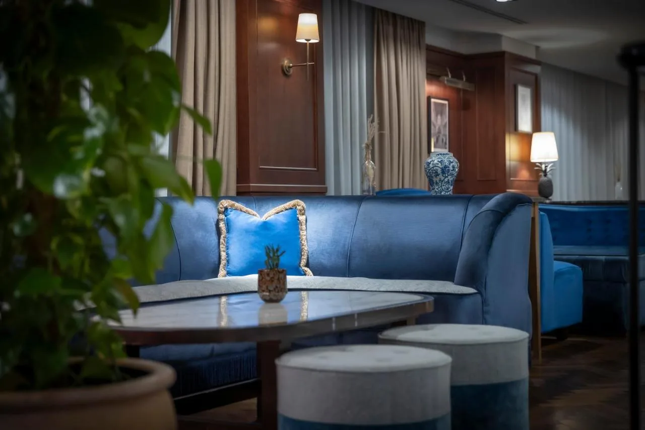 Lounge with blue couch near the lobby
